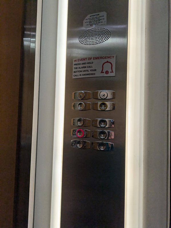 Image of lift panel. The lift buttons have Braille Markings