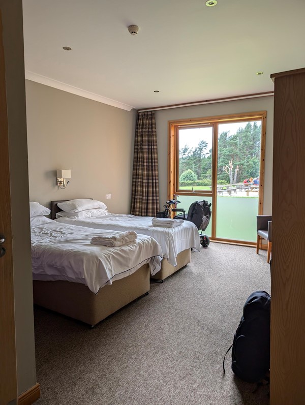 Spacious room with plenty of space for a wheelchair, scooter alongside the beds