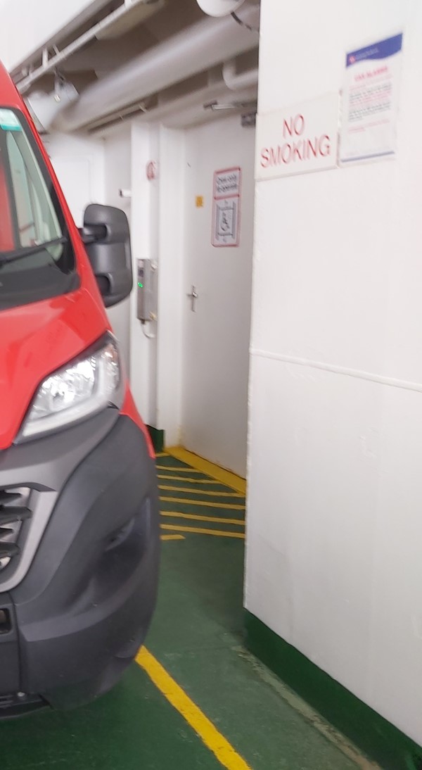 Image of a red van parked in a parking lot