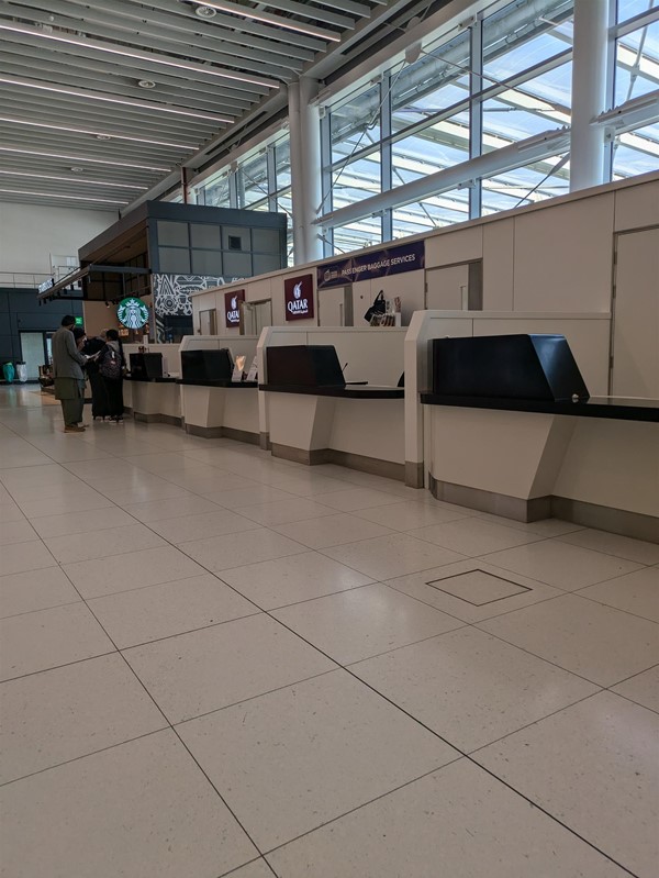 Image of Qatar Airways check in desk and Starbucks Kiosk