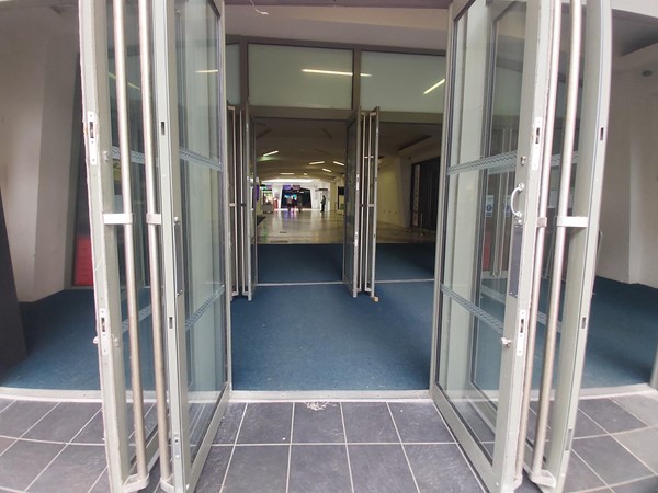 Image of glass doors open to a building