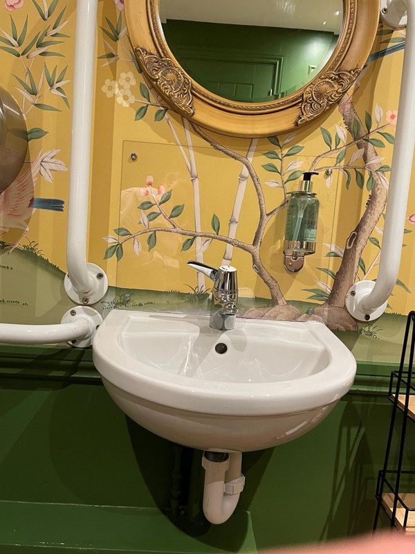Image of a sink with a mirror above it