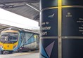 Image of a train, with a pillar that reads Welcome to Manchester Airport