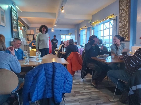 Image of a group of people sitting at tables in a restaurant