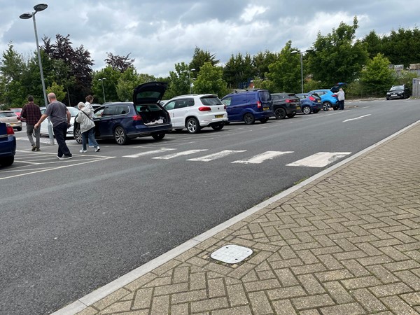 Image of vehicles parked in a crowded car park