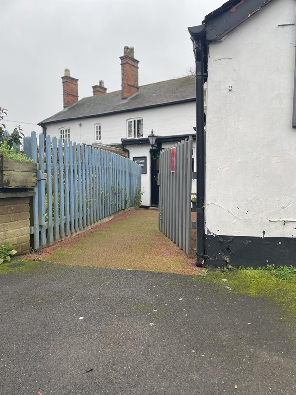 Image of a gate leading to a door