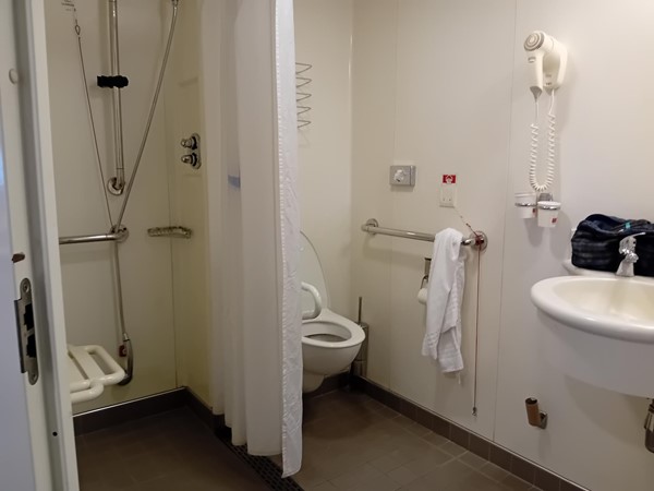 Accessible bathroom in our cabin with rails and sturdy shower seat