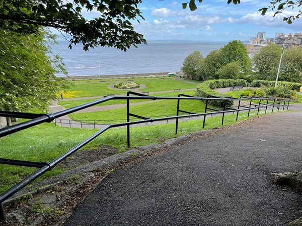 The view from the upper section of the park looking down to the lawns of the lower section and the seafront in the distance