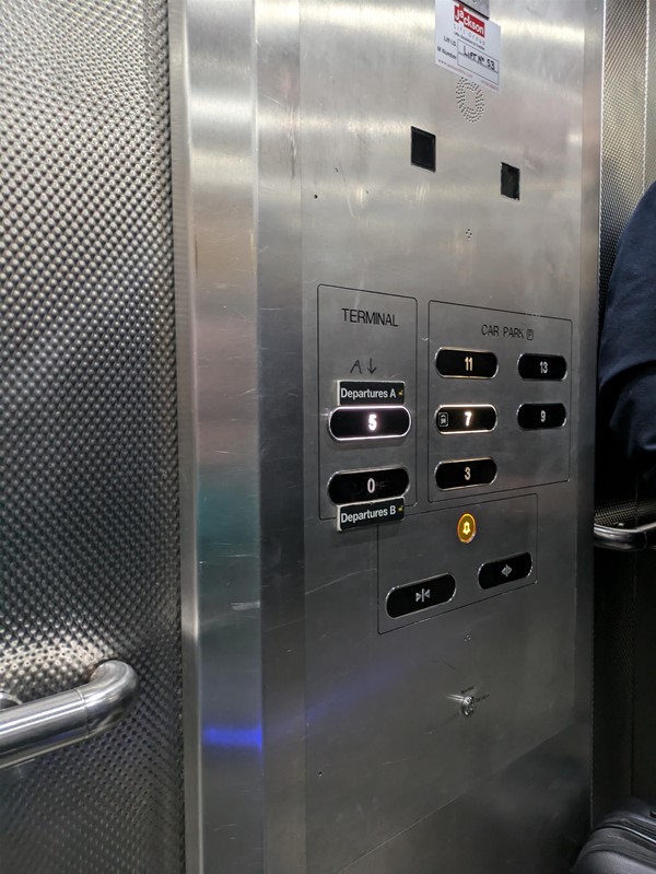 Image of the lift button panel. There are no braille buttons