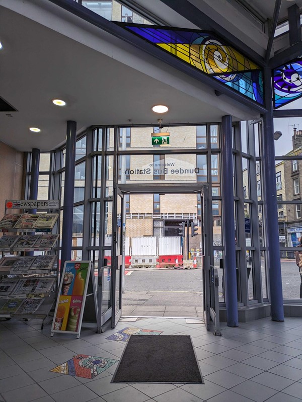 A glass door with a stained glass window