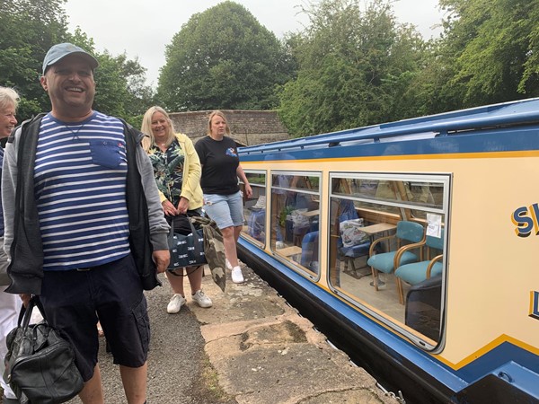 Picture of people standing by a narrow boat