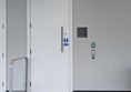 The entrance to the Changing Places Toilet. A white door with a touch pad to the right, and a small sign that reads Changing Places Toilet