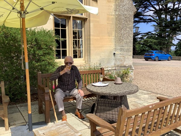 Man having a drink at a table outside