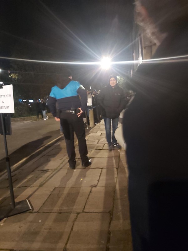 Image of people standing in a street