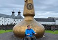 Image of a person in a wheelchair in front of a sculpture