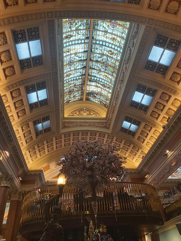 Image of a large ornate ceiling with a large window