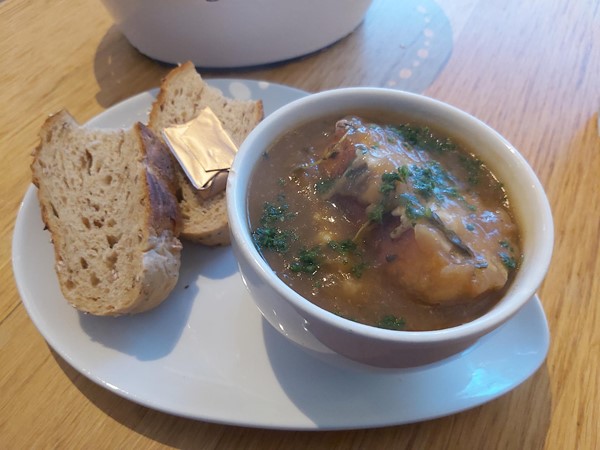 Image of a bowl of soup and bread on a plate