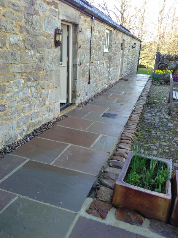 Rear of barn path. First door on left leads to bedroom, second door leads to living area.