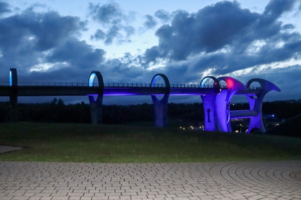 The wheel at night, lit up in blue and red.