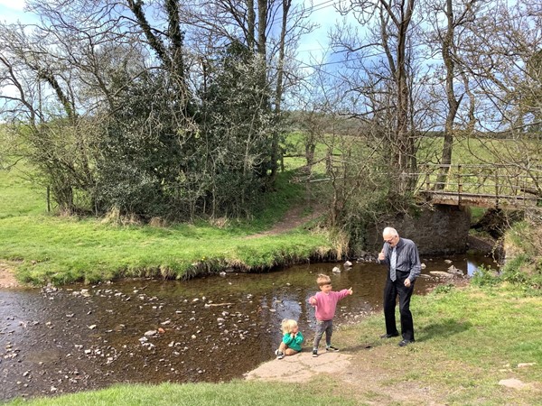 Picture of children in a pond with an adult