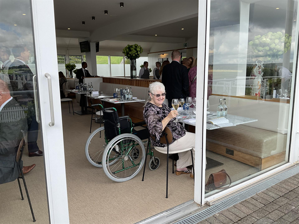 Image of a person sitting next to a wheelchair