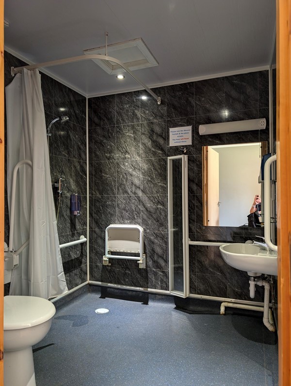 Large walk in shower with chair. Some improvements required, but a good start