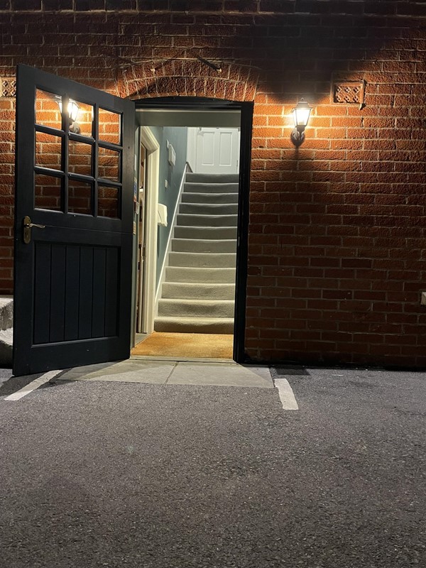 Image of an open door with stairs