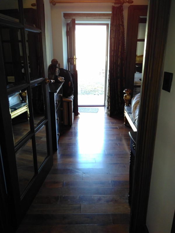 Left side of bed and rear entrance into barn.