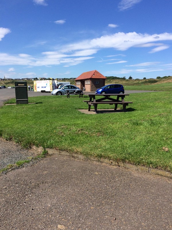 Picnic seats up on kerb.