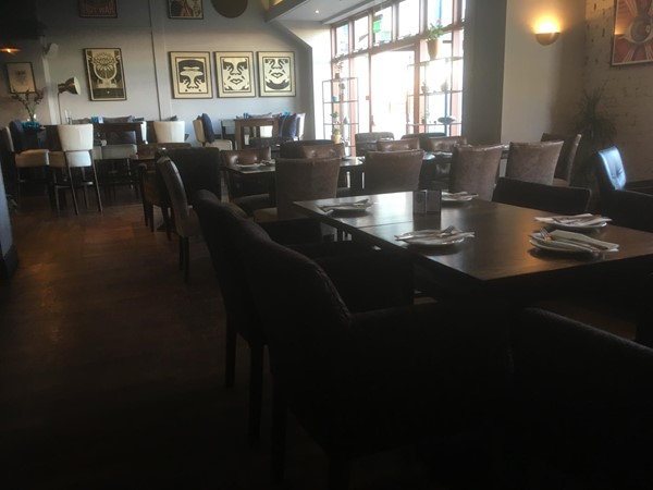 Spacious dining area with high tables enabling wheelchair access.