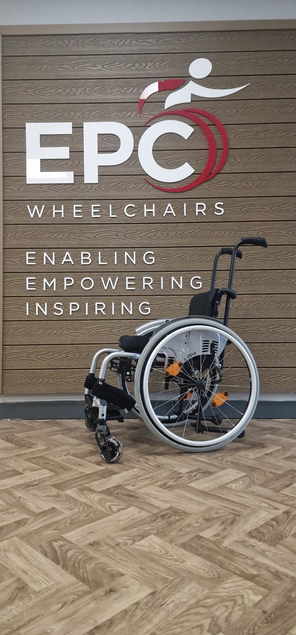 Image of a wheelchair in front of a sign