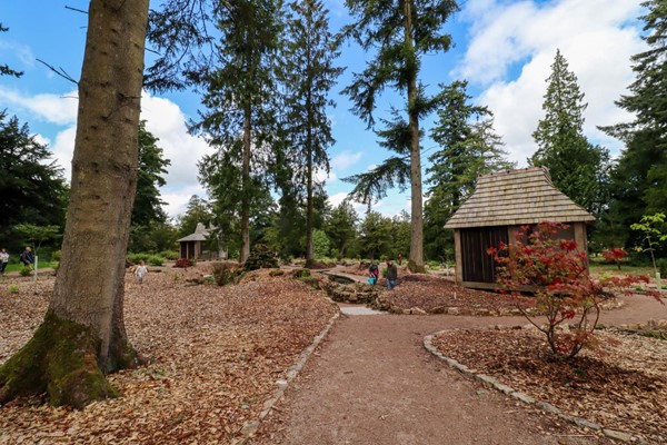 Gardens with marked paths which are wide and a hard dirt surface.